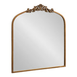 Rectangular arch-top mirror with a golden-brown wood frame and ornate floral carving centered along the arch's peak.