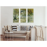 Three-panel framed canvas set depicting Vincent van Gogh's River Bank in Springtime with green foliage and a tree branch, hung above a beige sofa with patterned pillows and a knit throw.