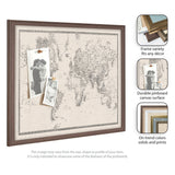 Framed linen pinboard featuring a vintage black and white world map with two sepia-toned photos pinned on its textured surface.