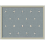 Blue rectangular pinboard with small, evenly spaced, white botanical block print motifs, framed in light beige wood.