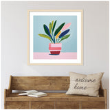 Framed playful still life painting of a potted plant with multicolored elongated leaves in a pink striped pot against a blue and pink background, hanging above a rustic wood bench.