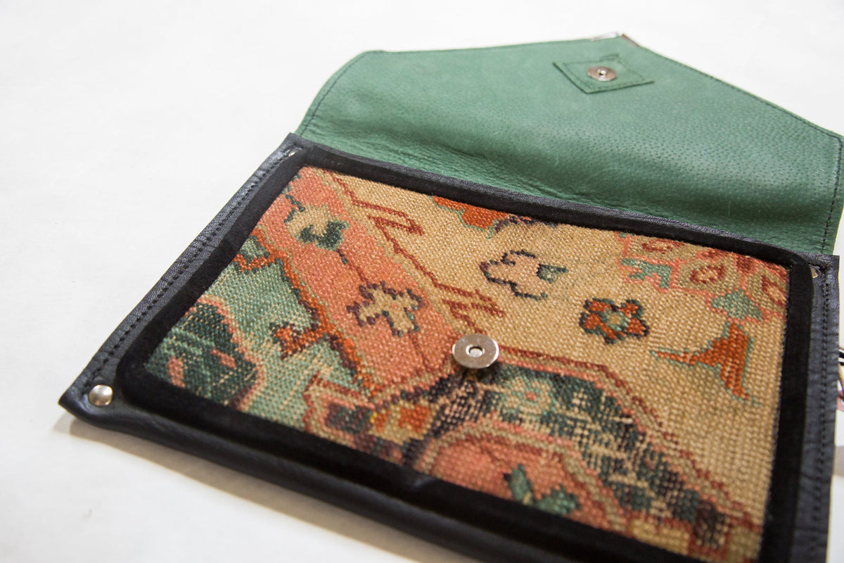 Handmade Rug Fragment Clutch showing a colorful rug fragment pattern with metal zipper and vegetable suede backing
