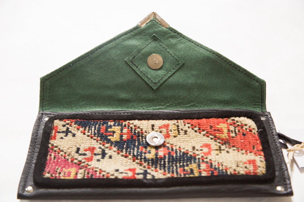 Handmade Rug Fragment Clutch featuring a colorful rug fragment, vegetable suede, and metal zipper