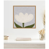 Framed canvas print of a minimalist white tulip with green leaves on a muted lavender background, hanging above a white desk with neutral decor.
