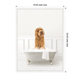 Curly-haired golden doodle sitting in a vintage clawfoot bathtub filled with bubbles, against a white paneled wall and hexagonal floor tiles.
