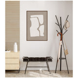Minimalist interior with abstract beige and white wall art above a black cushioned bench alongside a black metal coat rack holding a beige umbrella and hat.