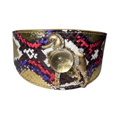 The Prince Of Beverly Hills Poodle Collar showing gold, white, red, and purple snake patterns with a clear rhinestone poodle rivet