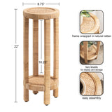 Tall round side table with natural rattan wrapping on frame and woven top and lower shelf, featuring two levels for display and storage, measuring 22 inches high.