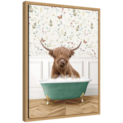 Framed canvas art showing a Highland cow relaxing in a bathtub placed in a meadow, by Amy Peterson