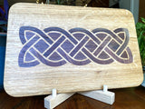 White Oak charcuterie board featuring a complex Celtic knot inlay made of Peruvian Walnut