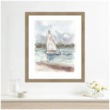 Watercolor painting of a sailboat on calm water with a hazy sky and distant shoreline, framed in light wood and displayed above a white shelf with flowers and candles.