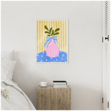 Framed canvas of a pink striped vase with green leaves and a blue-and-white striped bow, set against a yellow vertically striped background and blue polka dot surface.