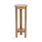 Tall round wooden side table with a smooth top and a small circular shelf near the base supported by three vertical legs in a light brown finish.