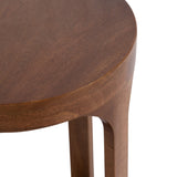 Close-up of smooth, rounded edge of a round wooden table top with matching curved wooden legs in warm brown finish.
