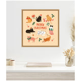 Framed square canvas with eight cartoon cats wearing Christmas accessories and the words Merry Christmas in red on a beige background, hanging above a white desk with neutral decor.