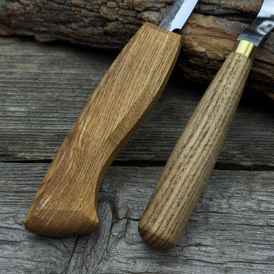 3-Piece Spoon Carving Tool Set with Leather Strop by Sharky Forged Steel Tools showing hook knife, sloyd knife, and leather strop on wooden surface