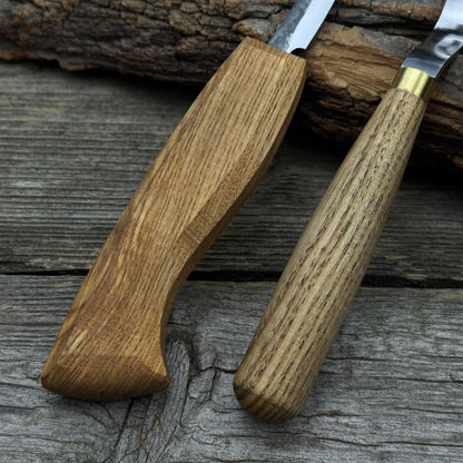 3-Piece Spoon Carving Tool Set with Leather Strop by Sharky Forged Steel Tools showing hook knife, sloyd knife, and leather strop on wooden surface