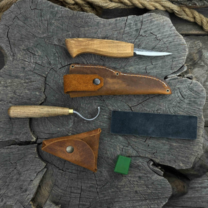 3-Piece Spoon Carving Tool Set with Leather Strop by Sharky Forged Steel Tools showing hook knife, sloyd knife, and leather strop on wooden surface