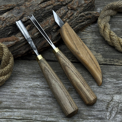 3-piece wood carving tool set with whittling knife, carving gouge, and V-parting chisel on a wooden surface
