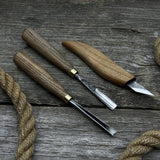 3-piece wood carving tool set with whittling knife, carving gouge, and V-parting chisel on a wooden surface