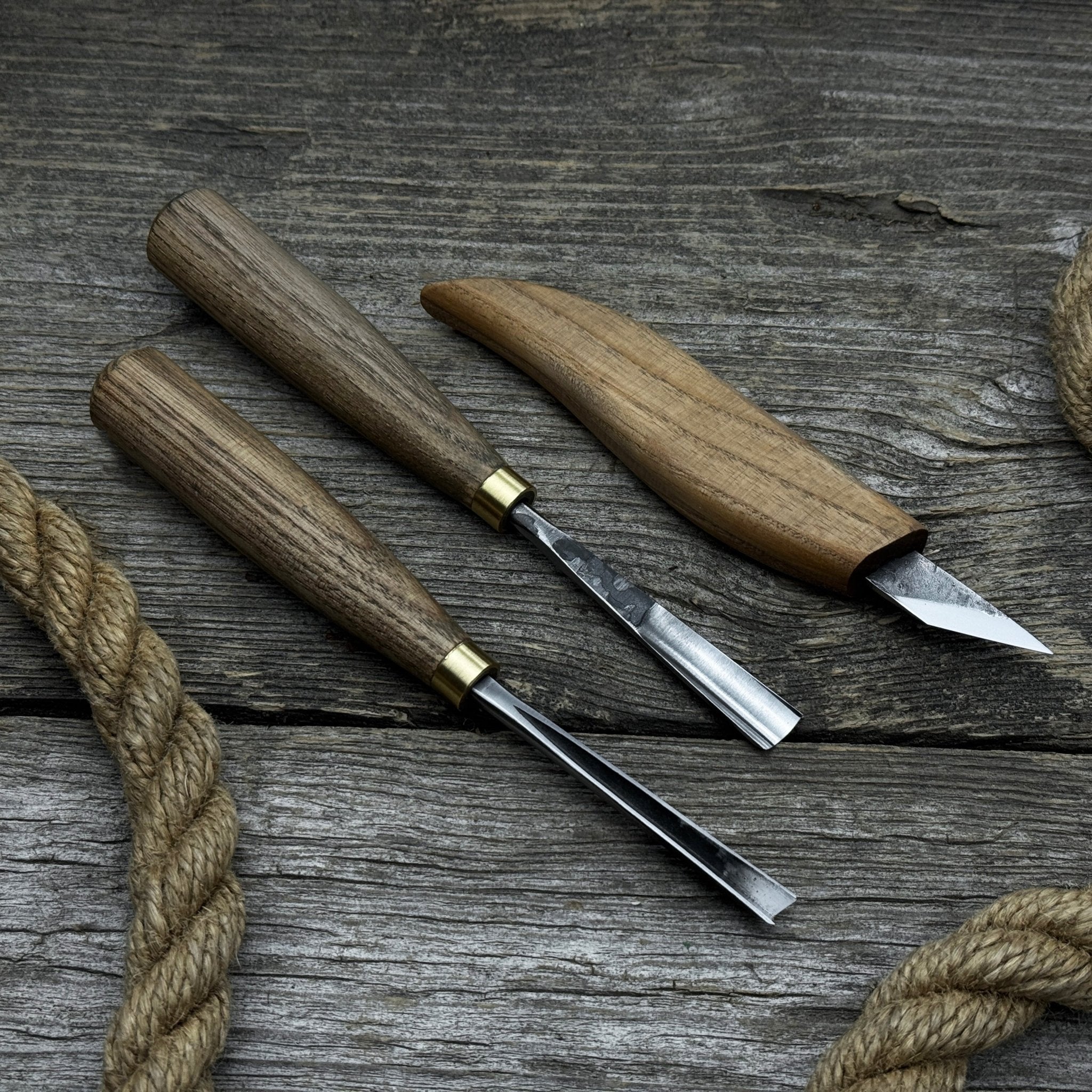 3-piece wood carving tool set with whittling knife, carving gouge, and V-parting chisel on a wooden surface