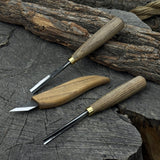 3-piece wood carving tool set with whittling knife, carving gouge, and V-parting chisel on a wooden surface