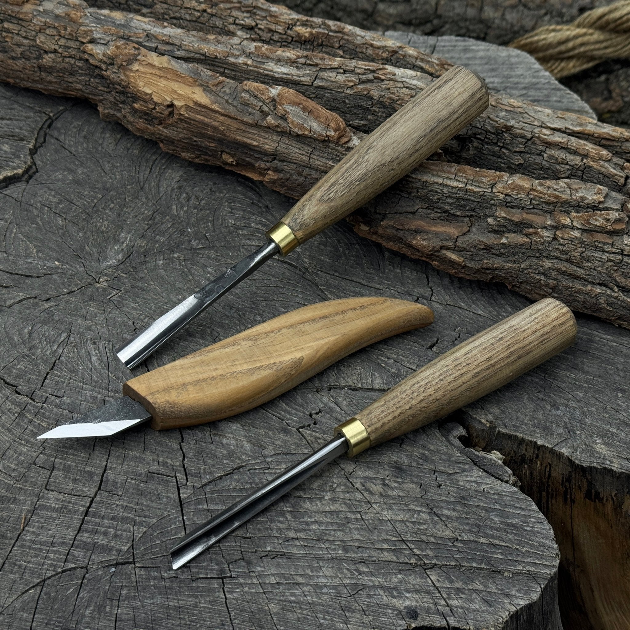 3-piece wood carving tool set with whittling knife, carving gouge, and V-parting chisel on a wooden surface