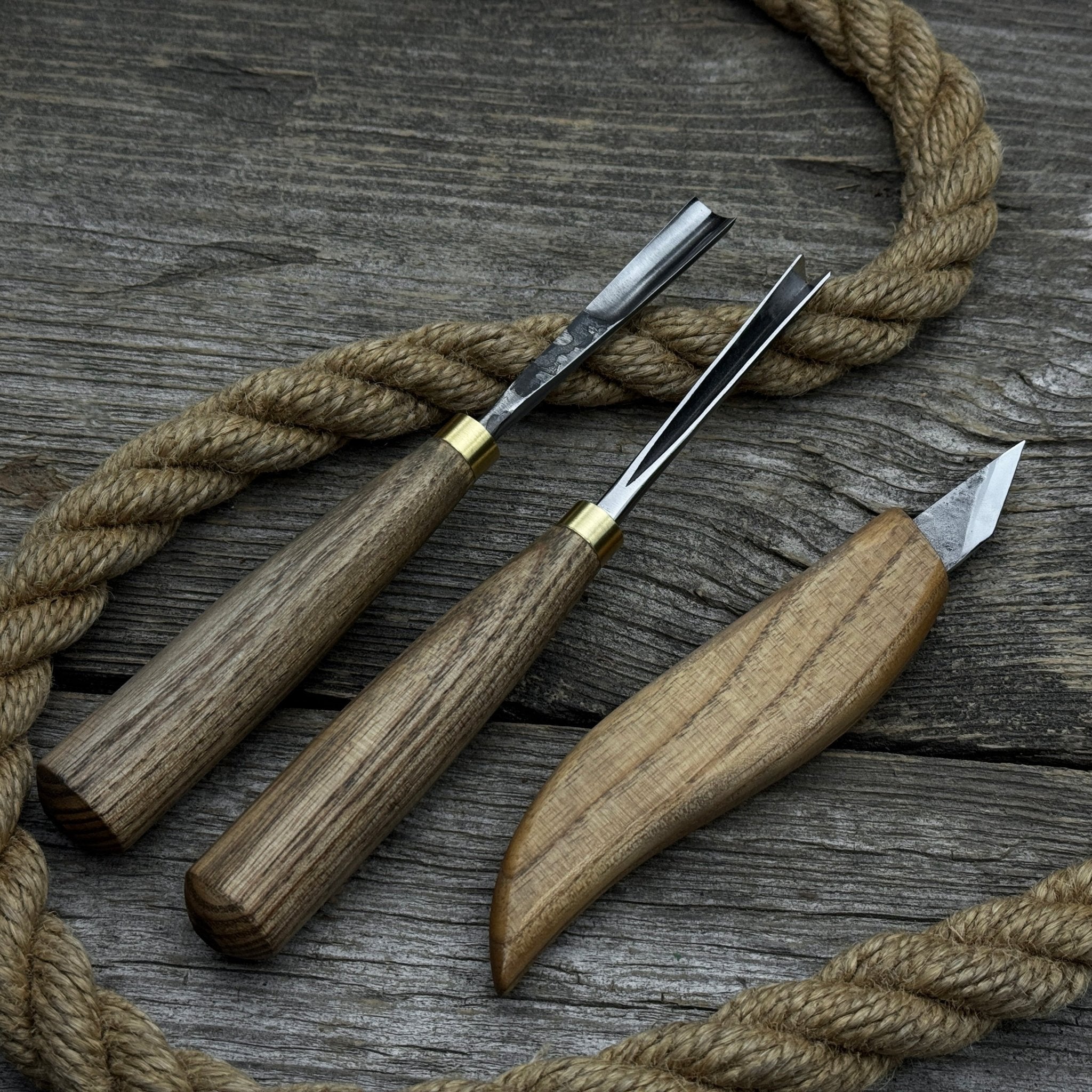 3-piece wood carving tool set with whittling knife, carving gouge, and V-parting chisel on a wooden surface