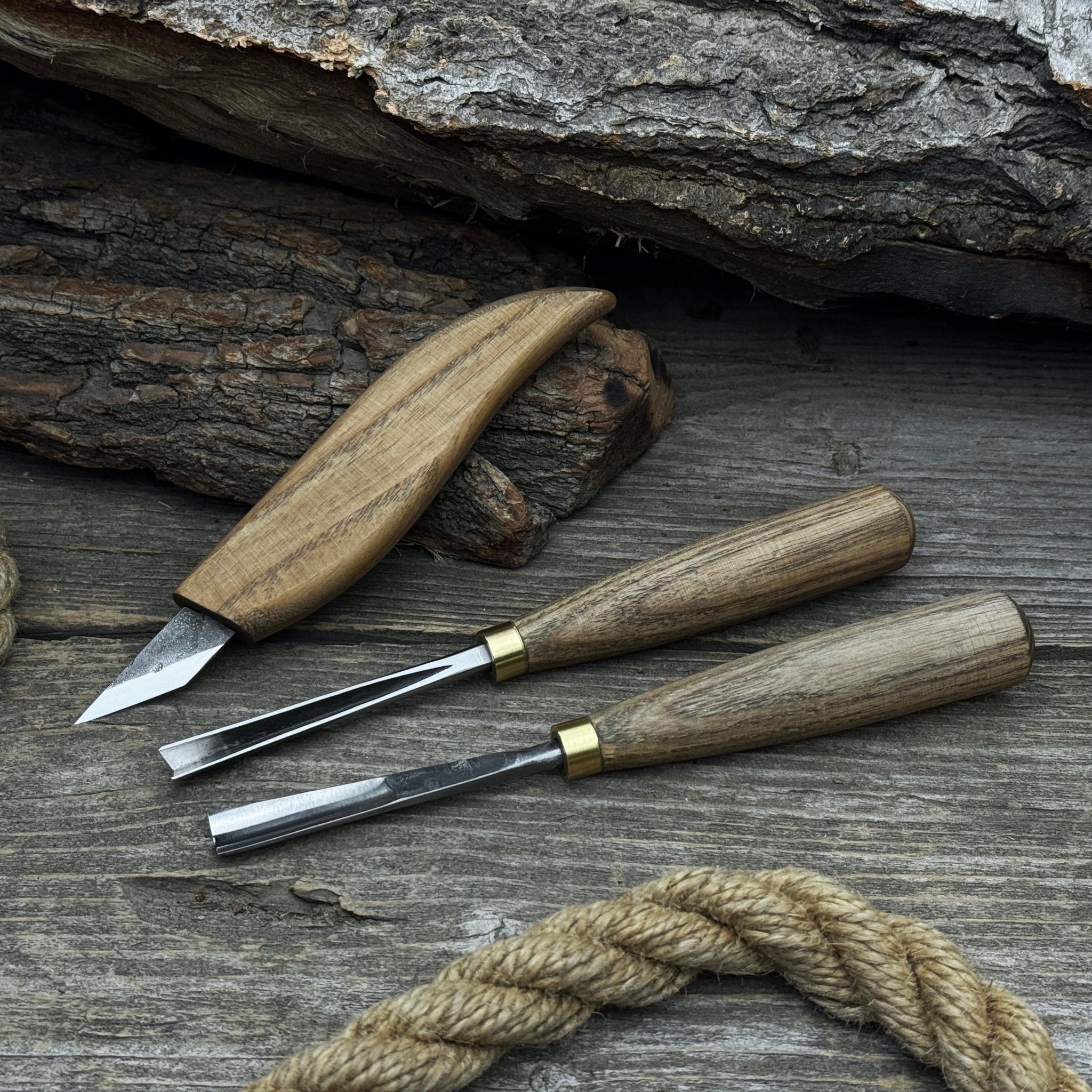 3-piece wood carving tool set with whittling knife, carving gouge, and V-parting chisel on a wooden surface