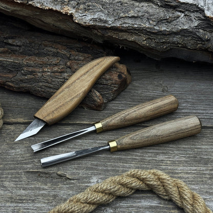 3-piece wood carving tool set with whittling knife, carving gouge, and V-parting chisel on a wooden surface
