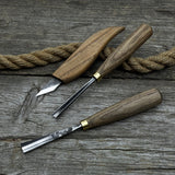 3-piece wood carving tool set with whittling knife, carving gouge, and V-parting chisel on a wooden surface