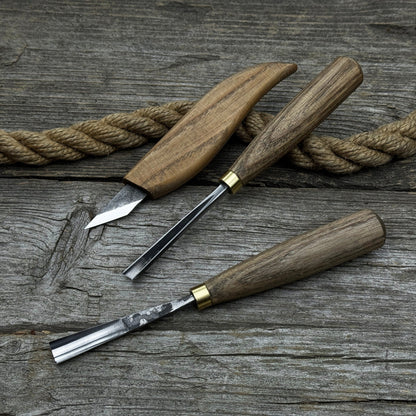 3-piece wood carving tool set with whittling knife, carving gouge, and V-parting chisel on a wooden surface