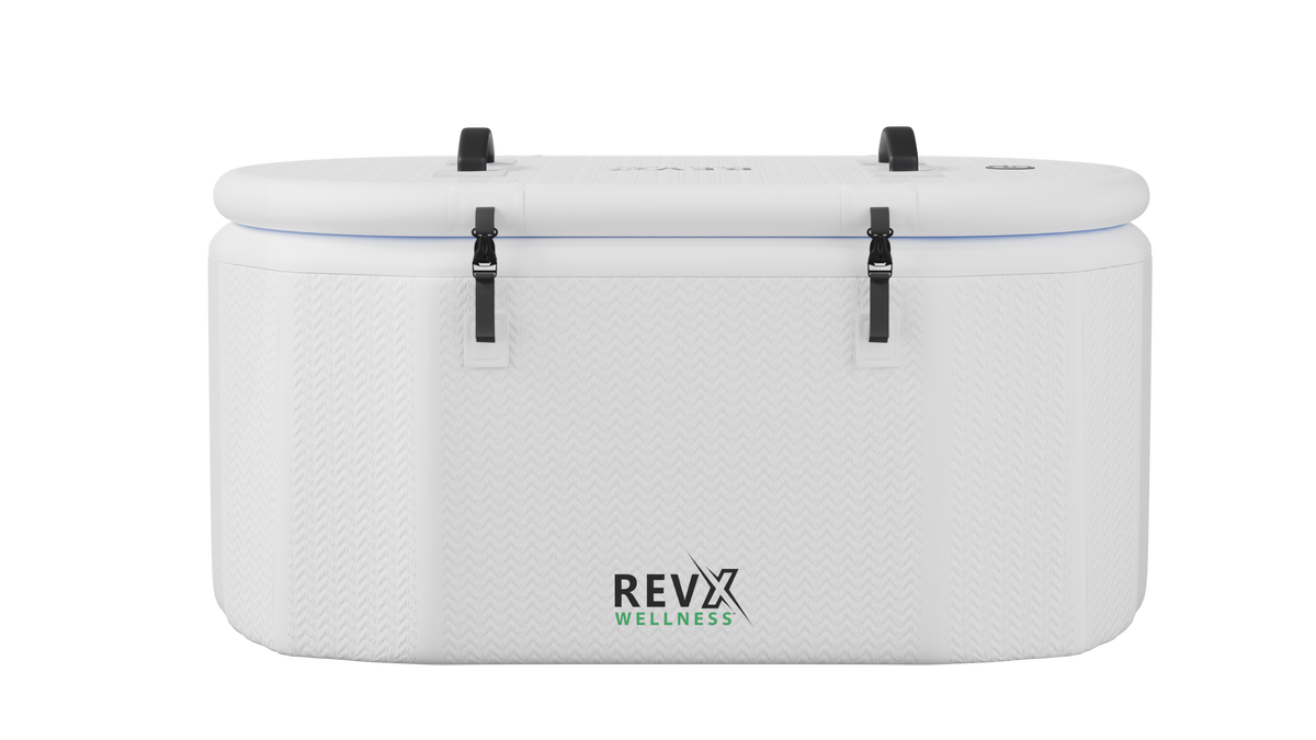 White rectangular inflatable tub with soft rounded edges and black buckle straps securing the closed lid, featuring the RevX Wellness logo on front center.