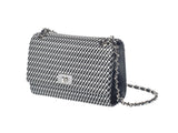 Rectangular black and white checkered shoulder bag with silver twist-lock clasp and a silver chain strap interwoven with black leather.