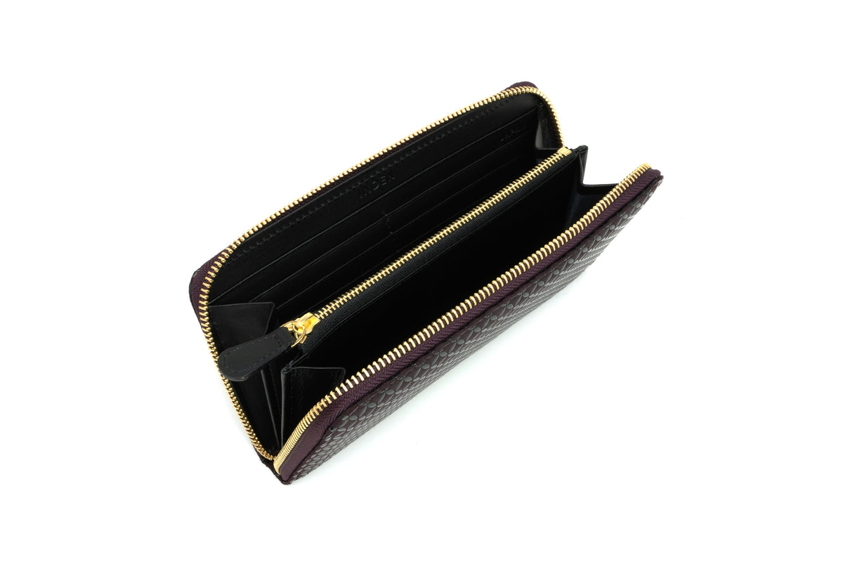 Open zipped long wallet featuring dark brown crocodile-patterned leather exterior and black interior with multiple card slots and compartments, trimmed with gold zipper.
