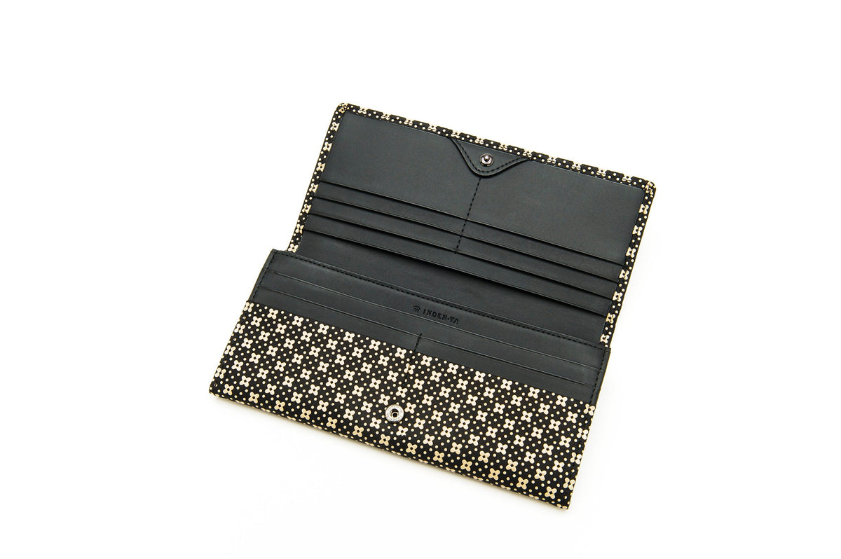 Open long wallet with black interior and multiple card slots, featuring a black and cream flower lattice pattern on the exterior and edges.