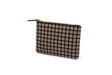 Rectangular black zippered pouch covered in a grid of light tan square studs with X-shaped indents, shown at a slight angle against a white background.