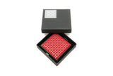 Red leather wallet with embossed geometric pattern inside an open black box with a silver logo on the lid, shown from above on a white background.