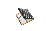 Compact square mirror with a reflective surface, featuring a black-and-white woven pattern cover and gold-tone frame edges, shown partially open on white background.