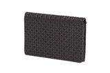Dark brown business card case with a repeating pattern of interlocking circular shapes embossed on its surface, shown standing upright against a white background.