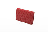 Red business card case with a subtle geometric pattern of interlocking circles, shown at a slight angle on a white background.
