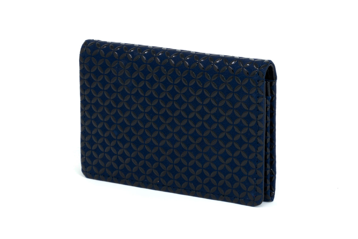 Dark blue rectangular business card case with a geometric circular pattern embossed over its surface, shown standing upright against a white background.
