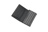 Open black business card case with a smooth interior flap and exterior featuring a black and white checkered geometric pattern.