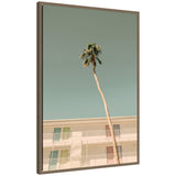 PS I Love You framed canvas wall art featuring a tall palm tree against pastel sky and colorful minimalist building framed in dark gold