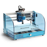 Blue desktop CNC router with transparent side panels and metal rails, featuring dimensions marked on the working area platform in millimeters and inches.