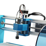 Close-up of a blue and silver CNC router spindle assembly with black and red wires, mounted on parallel metal guide rods and a blue frame.