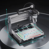 Compact desktop CNC router with silver aluminum frame and black spindle motor, showing a transparent work area with 300mm by 200mm dimensions highlighted by teal and red lines.