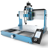 Compact Genmitsu 3030-PROVer Ultra desktop CNC router with blue and silver frame, perforated work surface, and touchscreen control panel angled on front right