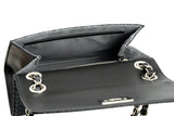 Open black shoulder bag showing smooth inner flap and grey fabric-lined interior with a zippered pocket and silver chain attachments.