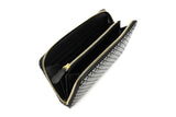 Black and white patterned zippered long wallet with a gold zipper and multiple card slots inside, shown from a top angled view on a white background.